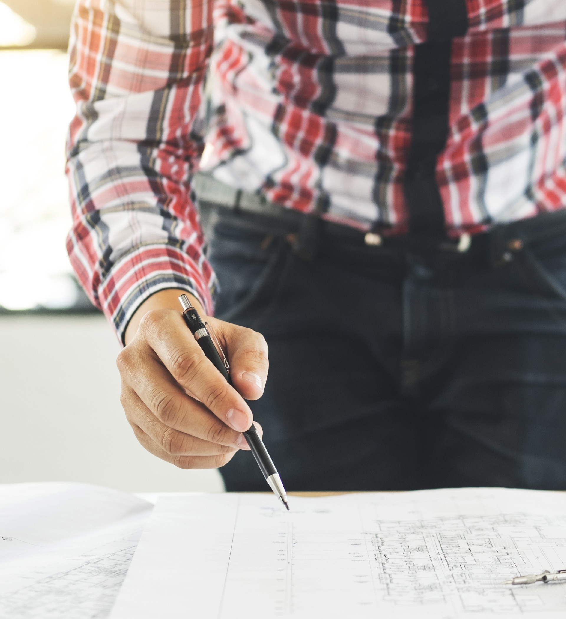 An architect looking over a blueprint