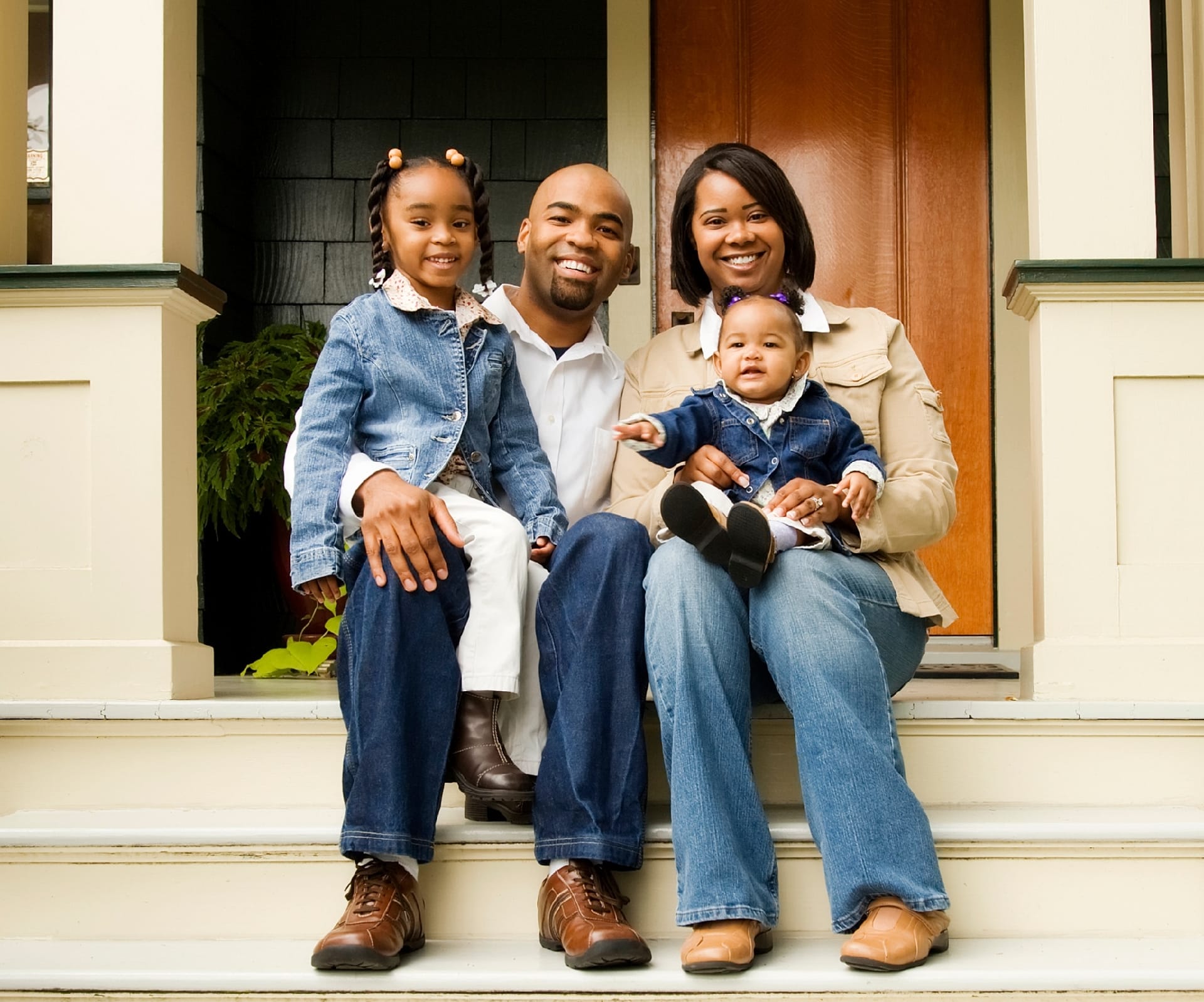 A family sitting on their front steps